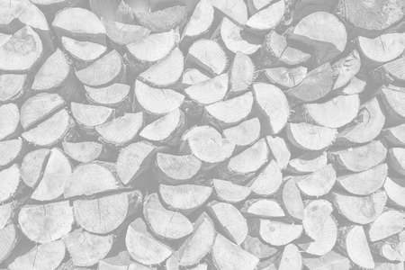 Pile of wood logs ready for winter. Image in light gray tonality