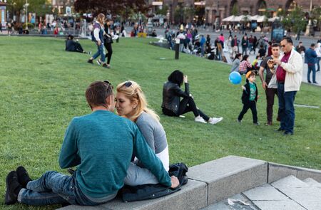 KYIV, UKRAINE - May 03, 2017: Young people resting on the green lawn on a sunny spring day. Citizens have a rest on the lawn at the Independence Squareのeditorial素材