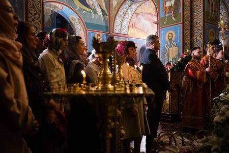 KYIV, UKRAINE - Apr. 28, 2019: President of Ukraine Petro Poroshenko together with his wife Maryna and son Mykhailo takes part in the Easter service at St. Michael's Cathedral in Kyivのeditorial素材