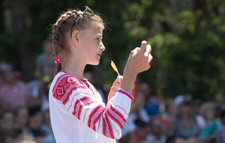 IVANO-FRANKIVSK REG, UKRAINE - Jun. 15, 2019: Girl with a smartphone at the festival Polonynsky Summer, traditional cultural festival at Hutsulshchynaのeditorial素材