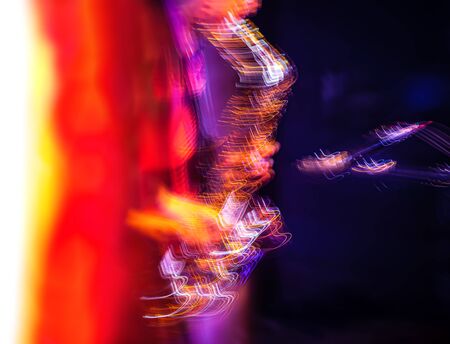 Jazz music concept. Abstract motion blurred image of saxophone player performing on stage. Sax...