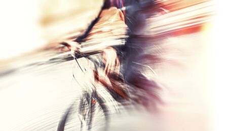 Abstract blurred image of cyclist on the city roadway. Intentional motion blurの写真素材