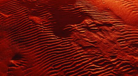 Dunes on the sea shore. Ripples in wet sand background texture. Beach sand backgroundの写真素材