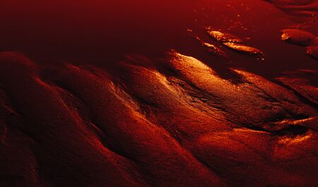 Dunes on the sea shore. Ripples in wet sand background texture. Beach sand backgroundの写真素材