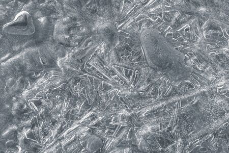 Nature background. Closeup image of ice patterns on the surface of frozen water