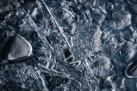 Nature background. Closeup image of ice patterns on the surface of frozen water