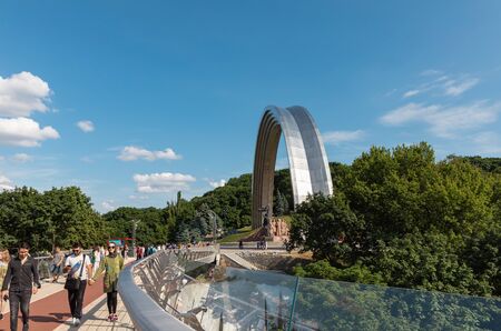 KIEV, UKRAINE - Jun 06, 2019: Crowd of people at new Pedestrian-Bicycle Bridge. New pedestrian bridge with a glass floor is a new touristic place and travel destination in Kyivのeditorial素材