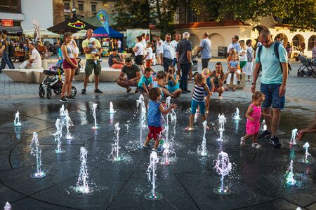 LUBLIN, POLAND - JULY 27, 2018: Happy children playing in a water fountain in Lublin. Lublin is the ninth largest city in Polandのeditorial素材