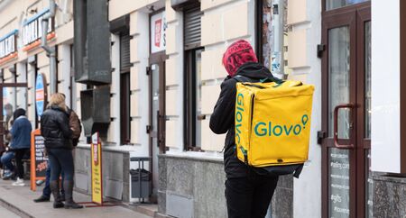 Kyiv, Ukraine - Nov. 16, 2019: A Glovo food delivery courier delivers food in Kyiv, Ukraine.のeditorial素材