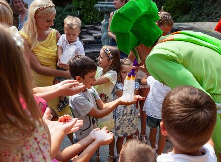 UZHGOROD, UKRAINE - Aug. 20, 2015: Clowns show soap bubbles to children during a children's holiday. Children and adults play soap bubblのeditorial素材