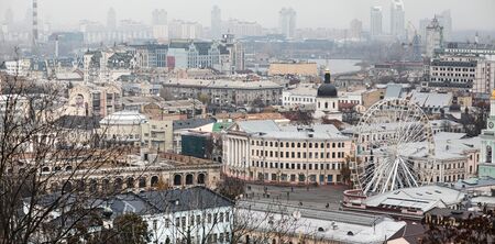 Kyiv, Ukraine - Nov. 16, 2019: Cityscape of Podol district in Kyiv city at foggy day. Kontraktova square and Ferris wheelのeditorial素材