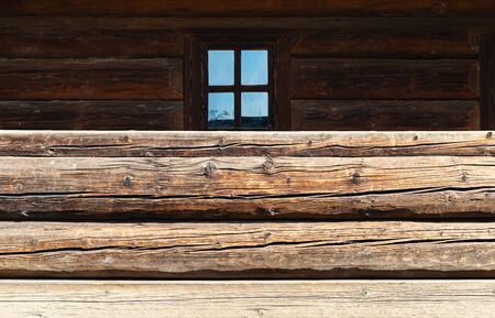 Fragment of a wooden house. Wooden wall from logs as a background textureの写真素材