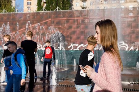 Kyiv, Ukraine - May. 03, 2017: Street scene in Kyiv, the capital of Ukraine. A group of young people near the fountain on the street Khreshchatyk in Kyivのeditorial素材
