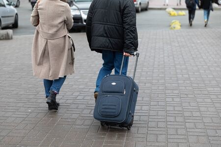 KYIV, UKRAINE - Sep 27, 2019: Street scene in Kyiv, the capital of Ukraine. A man drags a suitcase on wheels on the streets of Kievのeditorial素材