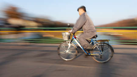 Abstract blurred image of cyclist on the city roadway. Intentional motion blurのeditorial素材