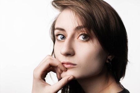 Happy teenage girl. Fashion, portrait and people concept. Portrait of a young emotional and stylish woman on a light background in the studioの写真素材