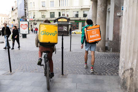 Lviv, Ukraine - May 25, 2020: A Glovo and Raketa food delivery couriers delivers food in Lviv, Ukraine.のeditorial素材