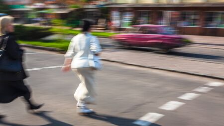 City life concept. People rushing in city. Abstract street scene in motion blur. Group of people at a pedestrian crossingの写真素材