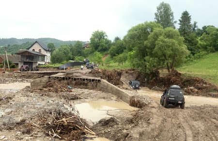 Carpathian reg. Ukraine - 28 Jun. 2020: Catastrophic flood in the western regions of Ukraine. Destroyed road and bridgeのeditorial素材