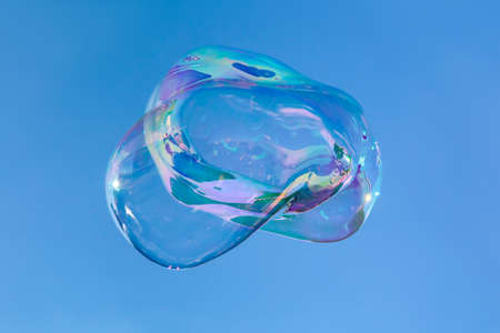Big transparent soap bubble against blue skyの写真素材