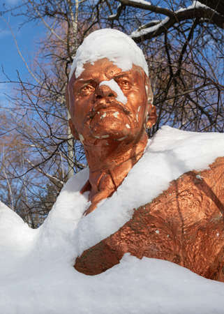 KYIV, UKRAINE - Jan. 31, 2021: Monuments of the era of totalitarianism collected in a snowy courtyard of a city apartment building in Kiev. Sculptures of Lenin and other leaders of the revolutionのeditorial素材