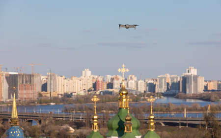 Drone flies over Vydubychi Monastery in Kyiv. Domes of the Christian monastery. Focus on drone with blurred backgroundの写真素材