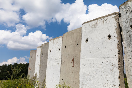 Old concrete slabs standing on a summer sunny day in the field. Old unfinished buildingの写真素材