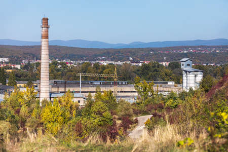 Large brick chimney. Tall factory chimney made of brick against blue skyの写真素材