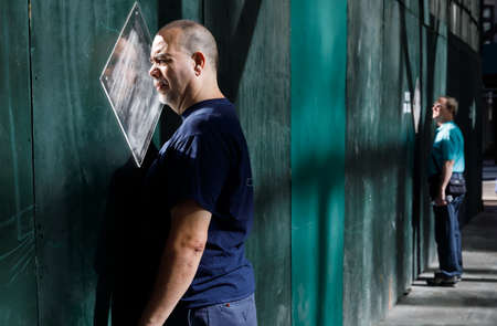 NEW YORK, USA - Sep 23, 2017: Manhattan street scene. People are looking out the window in the fence at construction sites in Manhattanのeditorial素材
