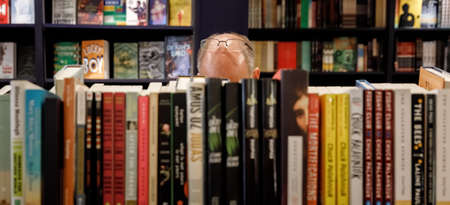 NEW YORK, USA - Sep 23, 2017: Book Store in Manhattan. A man with glasses on his forehead chooses books in a bookstoreのeditorial素材