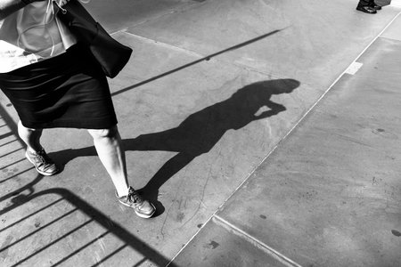 Light and shadows in New York City. Shadows of people walking street in morning lightの写真素材