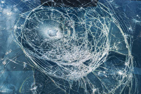 Car glass shattered by a stone. Broken car windshield. Criminal incidents. Vandals, hooligans...