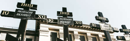 KYIV, UKRAINE - Feb. 22, 2022: The empire must die. Protest action near the Embassy of the Russian Federation in Kiev. Grave cross with the inscription Russian occupierのeditorial素材
