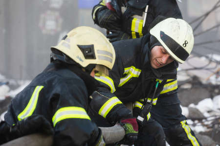 KYIV, UKRAINE - Feb. 25, 2022: War of Russia against Ukraine. Rescue service works near a house destroyed by russian rocket in Kyivのeditorial素材