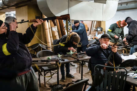 KYIV, UKRAINE - Feb. 28, 2022: War of Russia against Ukraine. A large number of civilians enrolled in the territorial defense units. Territorial defense fighters prepare weapons to defend the cityのeditorial素材