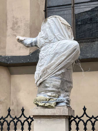 LVIV, UKRAINE - Mar. 02, 2022: War in Ukraine. In Lviv, monuments and buildings of historical value are being prepared for a possible bombardment. Sculptures are covered with a protective film.のeditorial素材