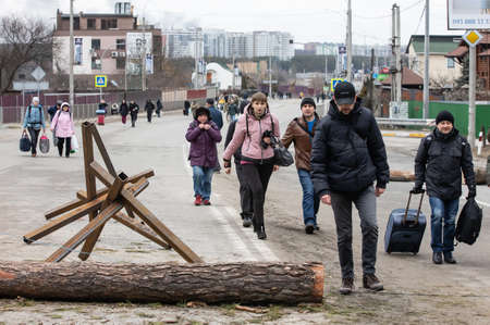 IRPIN, UKRAINE - Mar. 05, 2022: War of Russia against Ukraine. Women, old people and children evacuated from Irpin town was transferred to Kyiv by Kyiv territorial defense battalion. War refugees in Ukraineのeditorial素材