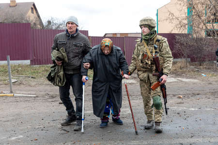 IRPIN, UKRAINE - Mar. 05, 2022: War of Russia against Ukraine. Women, old people and children evacuated from Irpin town was transferred to Kyiv by Kyiv territorial defense battalion. War refugees in Ukraineのeditorial素材