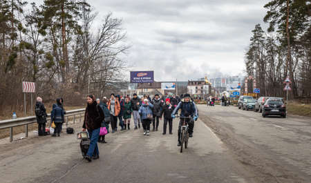 IRPIN, UKRAINE - Mar. 05, 2022: War of Russia against Ukraine. Women, old people and children evacuated from Irpin town was transferred to Kyiv by Kyiv territorial defense battalion. War refugees in Ukraineのeditorial素材