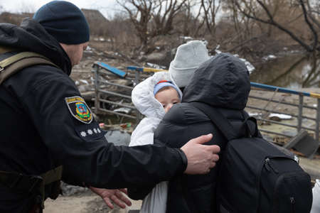 IRPIN, UKRAINE - Mar. 09, 2022: War in Ukraine. Thousands of residents of Irpin have to abandon their homes and evacuate as russian troops are bombing a peaceful city. War refugees in Ukraineのeditorial素材