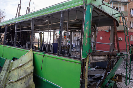 KYIV, UKRAINE - Mar. 14, 2022: War in Ukraine. Devastation and death on the streets of Kyiv as a result of a rocket attack by Russian occupiers of civilian. Trolley bus destroyed by Russian rocketのeditorial素材