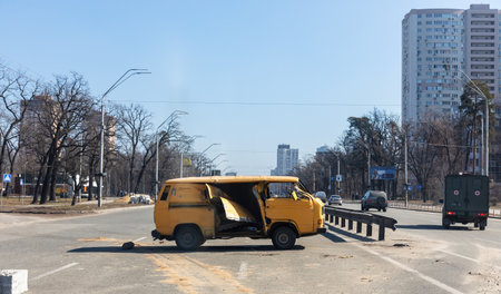 KYIV, UKRAINE - Mar. 15, 2022: War of Russia against Ukraine. Broken car on street of Kyiv during the war.のeditorial素材