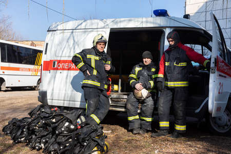 KYIV, UKRAINE - Mar. 15, 2022: War in Ukraine. A team of firefighters on the streets of Kyiv is...
