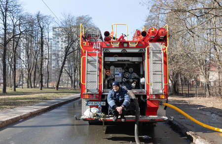 KYIV, UKRAINE - Mar. 15, 2022: War in Ukraine. A team of firefighters on the streets of Kyiv is ready to help the victims at any time. Firefighters after completing the assigned taskのeditorial素材
