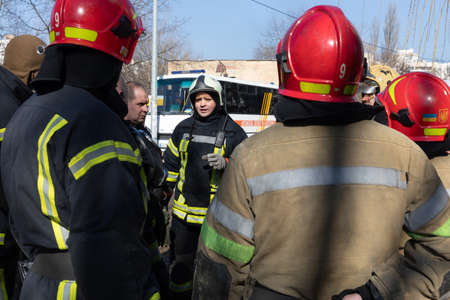 KYIV, UKRAINE - Mar. 15, 2022: War in Ukraine. A team of firefighters on the streets of Kyiv is...