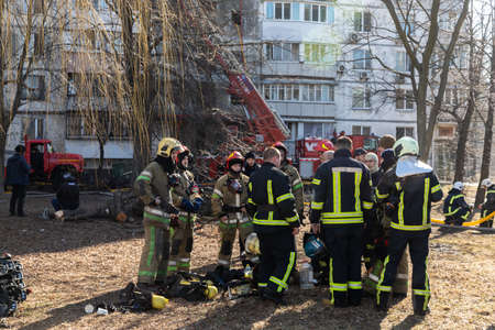 KYIV, UKRAINE - Mar. 15, 2022: War in Ukraine. A team of firefighters on the streets of Kyiv is ready to help the victims at any time. Firefighters after completing the assigned taskのeditorial素材