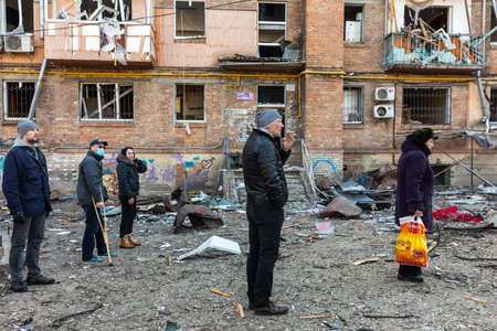 KYIV, UKRAINE - Mar. 18, 2022: War in Ukraine. Damaged residential buildings in the aftermath of a shelling in Podilskyi district of Kyiv. At least one person was reportedly killed and 19 were injuredのeditorial素材