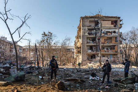 KYIV, UKRAINE - Mar. 18, 2022: War in Ukraine. Damaged residential buildings in the aftermath of a shelling in Podilskyi district of Kyiv. At least one person was reportedly killed and 19 were injuredのeditorial素材