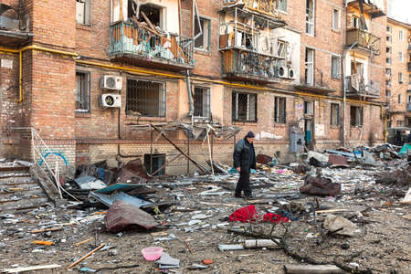 KYIV, UKRAINE - Mar. 18, 2022: War in Ukraine. Damaged residential buildings in the aftermath of a shelling in Podilskyi district of Kyiv. At least one person was reportedly killed and 19 were injuredのeditorial素材