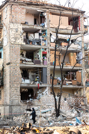 KYIV, UKRAINE - Mar. 18, 2022: War in Ukraine. Damaged residential buildings in the aftermath of a shelling in Podilskyi district of Kyiv. At least one person was reportedly killed and 19 were injuredのeditorial素材